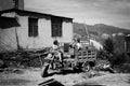 Children playing on the tractor near an abandoned building