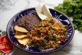 Yucatecan cuisine with our Huevo con Chaya. Scrambled eggs with indigenous chaya, succulent tomatoes, onion, refried beans, and Royalty Free Stock Photo