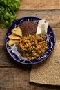 Yucatecan cuisine with our Huevo con Chaya. Scrambled eggs with indigenous chaya, succulent tomatoes, onion, refried beans, and Royalty Free Stock Photo