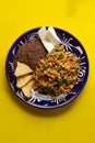 Yucatecan cuisine with our Huevo con Chaya. Scrambled eggs with indigenous chaya, succulent tomatoes, onion, refried beans, and Royalty Free Stock Photo