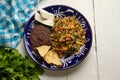 Yucatecan cuisine with our Huevo con Chaya. Scrambled eggs with indigenous chaya, succulent tomatoes, onion, refried beans, and Royalty Free Stock Photo