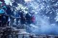 Tourists looking to the Snow Monkey Baby in Jigokudani Park Royalty Free Stock Photo