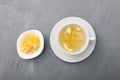 Yujacha yuja tea or yuzu tea - Korean citrus tea, made by mixing hot water with yuja marmalade. Grey background, top view Royalty Free Stock Photo