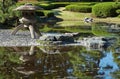 Yukimi-doro toro lantern near the pond in Ninomaru Garden. Tokyo Imperial Palace. Tokyo. Japan Royalty Free Stock Photo