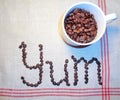 Yum, Message of Delicious Flavor, Spelled out with Coffee Beans Royalty Free Stock Photo