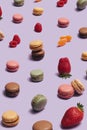 Yummy artisan patisserie concept. Many macarons, different color and taste arranged with strawberry, raspberry and mandarin