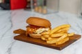 Yummy big cheeseburger with juicy cutlet in wooden tray. Fresh tasty Fast food set, hamburger and French fries. hamburger Royalty Free Stock Photo