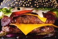 Yummy black burger grilled with double meat cutlet and melted cheese Royalty Free Stock Photo