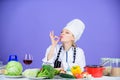 Yummy cooking. Kitchen maid showing OK gesture. Pretty woman cooking in restaurant kitchen. Professional cook confident Royalty Free Stock Photo
