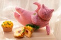 Yummy cupcake and textile cat on light background