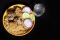 Yummy delicious Indian Chicken Biriyani on yellow plate isolated on black background. Royalty Free Stock Photo