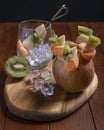 Yummy fruit skewers with apple, mandarin and kiwi on wooden table Royalty Free Stock Photo