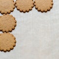 Yummy Ginger cookies on baking paper, traditional Christmas treat. Gingerbread background. Text space, empty template Royalty Free Stock Photo