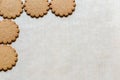 Yummy Ginger cookies on baking paper, traditional Christmas treat. Gingerbread background. Text space, empty template Royalty Free Stock Photo