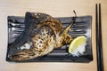Yummy grilled salmon head served on the table