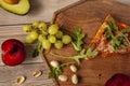 Yummy homemade stone baked pizza served with fresh fruits