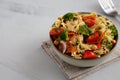 Yummy Homemade Vegan Pasta Salad with Tomato, Onion, Carrot, Broccoli, Chickpeas and Parsley in a Bowl, side view. Copy space Royalty Free Stock Photo