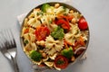 Yummy Homemade Vegan Pasta Salad with Tomato, Onion, Carrot, Broccoli, Chickpeas and Parsley in a Bowl, top view Royalty Free Stock Photo