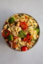 Yummy Homemade Vegan Pasta Salad with Tomato, Onion, Carrot, Broccoli, Chickpeas and Parsley in a Bowl, top view Royalty Free Stock Photo