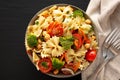 Yummy Homemade Vegan Pasta Salad with Tomato, Onion, Carrot, Broccoli, Chickpeas and Parsley in a Bowl, top view Royalty Free Stock Photo