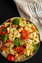 Yummy Homemade Vegan Pasta Salad with Tomato, Onion, Carrot, Broccoli, Chickpeas and Parsley in a Bowl, top view Royalty Free Stock Photo