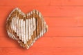 Yummy loaf shaped as heart over orange paneling