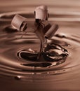 Melted chocolate splashing with falling curls Royalty Free Stock Photo