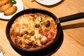 Yummy pan four portion pizza on the wooden table with grilled chicken