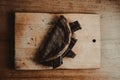 Yummy pancake with chocolate on a cutting board on a wooden table Royalty Free Stock Photo