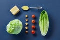 Yummy top view composition of fresh healthy salad ingredients on dark background. Royalty Free Stock Photo