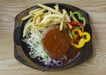 Vegetarian pork steak and side dish in hot pan on wooden block Royalty Free Stock Photo