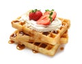 Yummy waffles with whipped cream, strawberries and caramel syrup Royalty Free Stock Photo