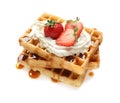 Yummy waffles with whipped cream, strawberries and caramel syrup Royalty Free Stock Photo