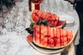 yummy watermelon slices on plate on table at luxury wedding reception. expensive catering. delicious fruits for summer