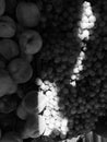 Yumy Grapes and delicious Peaches are wonderfully illuminated in black & white natural light & sunshine Royalty Free Stock Photo