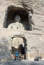 Buddha statue seen through opening at Yungang Grottoes near Datong in Shanxi Province, China Royalty Free Stock Photo