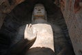 Buddha statue with hand raised at Yungang Grottoes near Datong in Shanxi Province, China Royalty Free Stock Photo