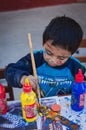 Yungay, Peru, August 4, 2014: portrait of happy naughty peruvian boy with face and clothes stained with paint doing crafts Royalty Free Stock Photo