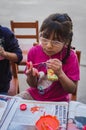 Yungay, Peru, August 4, 2014: portrait of humble latin girl with glasses and brush painting crafts