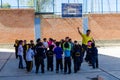 Yungay, Peru, July 14, 2014:  San Viator schoolyard with young children playing in a circle next to the teacher and basketball Royalty Free Stock Photo