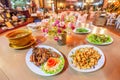 Yunnanese cuisine set, grilled chicken, fried pork, soup and spicy tea leaf salad, yunnan food in a local restaurant at Doi Mae