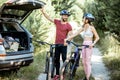 Yuong couple with bicycles on the forest road Royalty Free Stock Photo