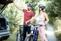 Yuong couple with bicycles on the forest road Royalty Free Stock Photo