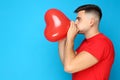 Yuong man blowing balloon Royalty Free Stock Photo