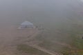 Yurt in a mist in Trans-Ili Alatau Zailiyskiy Alatau mountain range near Almaty, Kazakhst Royalty Free Stock Photo