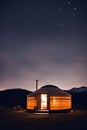 Yurt in the mountains at night with starry sky