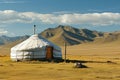 A yurt, a traditional portable tent, is seen in the middle of a field, set against a backdrop of majestic mountains, A traditional