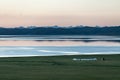 yurts sunset shore of calm mountain lake