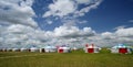 Yurts under blue sky and white clouds