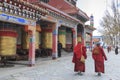 Tibetan people and monks walking around the Mani Temple Mani Shicheng a famous landmark in the Tibetan city of Yushu Jyekundo, Qin